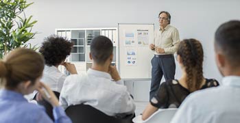 Lecturer showing charts on flipboard